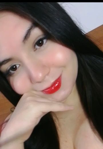 Woman resting her chin on her hand during a video chat